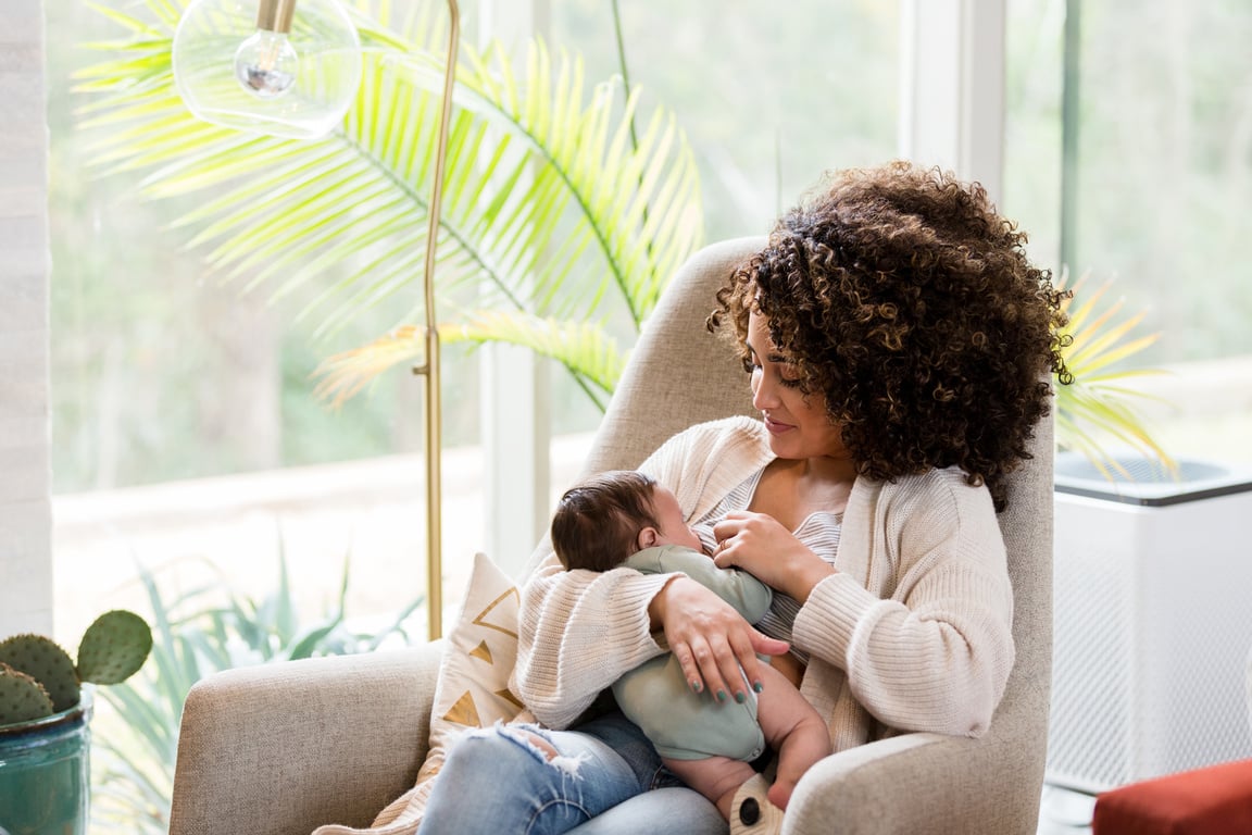 Mom breastfeeds newborn baby